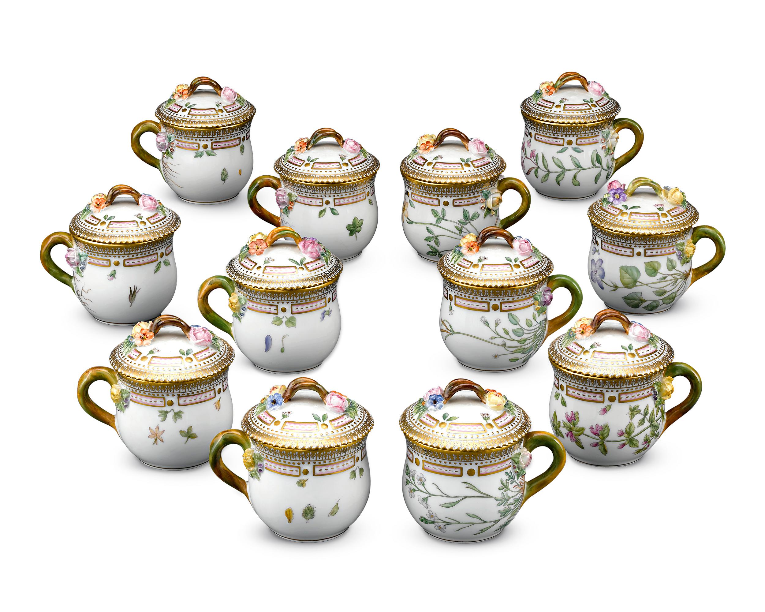 This extraordinary porcelain covered cups are the work of the legendary Royal Copenhagen. Crafted in the beloved Flora Danica pattern, one of the most prestigious porcelain patterns ever created, this stunning set of twelve incorporates the motif’s