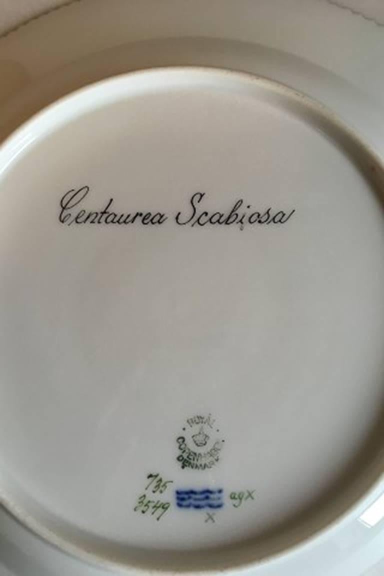 Royal Copenhagen Flora Danica dinner plate #735/3549. 
Latin name: Centaurea Scabiosa
Measures 25.5 cm / 10 3/64 inches. 2nd quality.