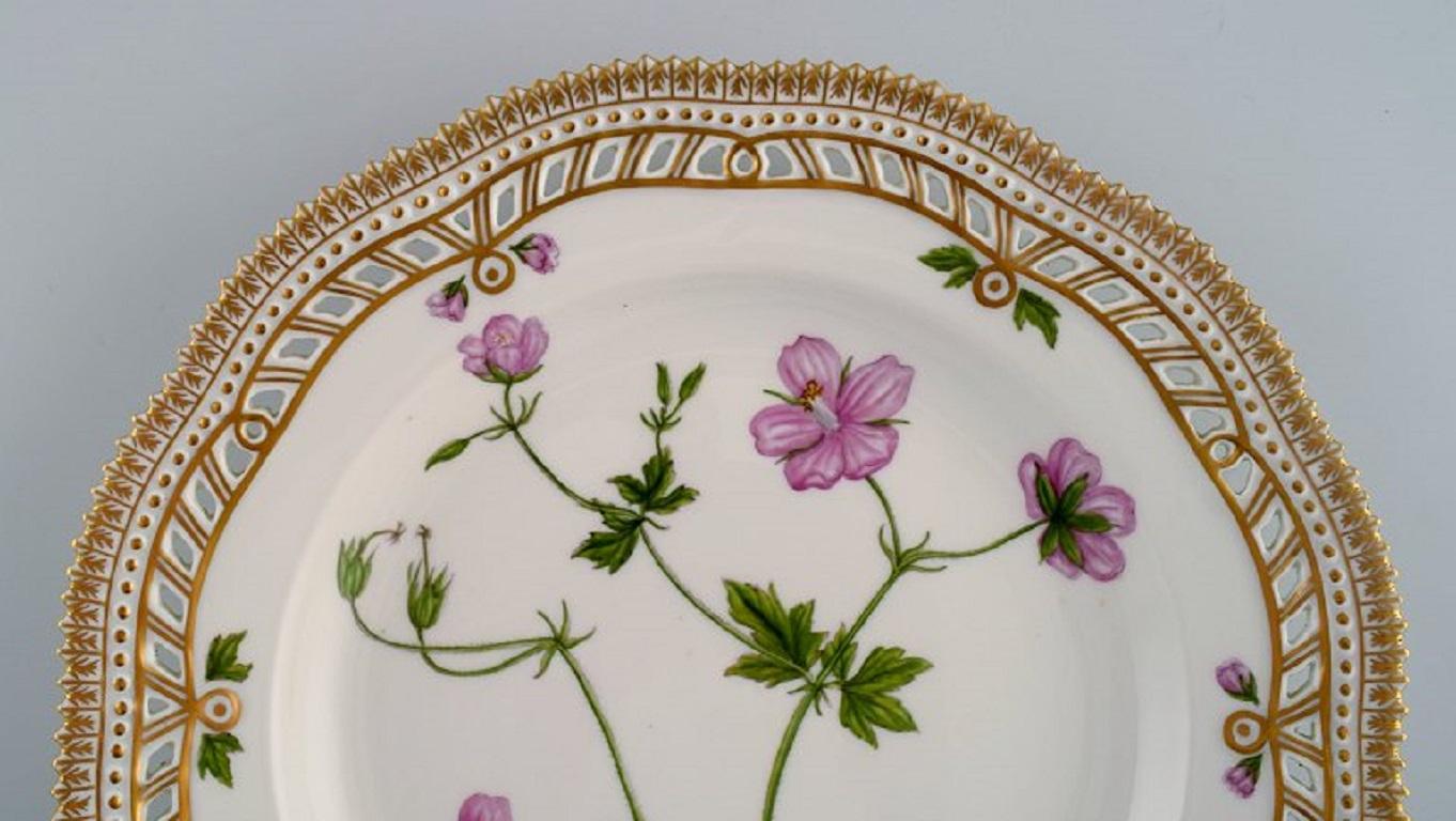 Royal Copenhagen Flora Danica dinner plate in openwork porcelain with hand-painted flowers and gold decoration. 
Model number 20/3553.
Measure: Diameter: 25.5 cm.
In perfect condition.
1st factory quality.
Stamped.