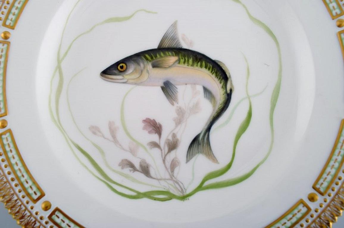 Royal Copenhagen Flora Danica fish plate in hand-painted porcelain with fish and gold decoration. 
Model number 19/3549.
Diameter: 25.5 cm.
In perfect condition.
1st factory quality.
Stamped.