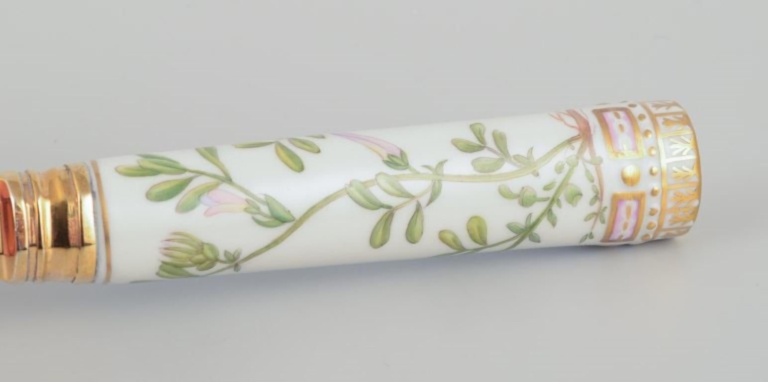 Gilt Royal Copenhagen Flora Danica/Georg Jensen.  Dining spoon with porcelain handle