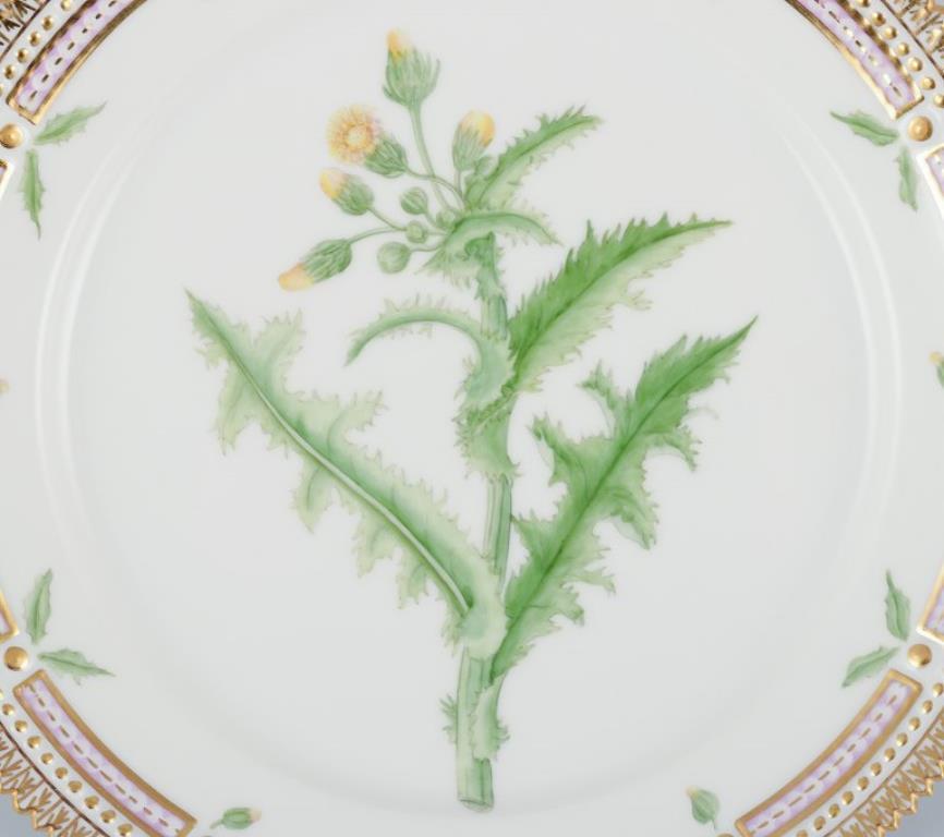 Plato de almuerzo Flora Danica de Royal Copenhagen, de porcelana pintada a mano con flores y decoración dorada. 
Model No: 20/3572
Fechado: 1960
Nombre latino.
En perfecto estado.
Primera calidad de fábrica.
Marcado.
Diámetro: 22,3 cm.