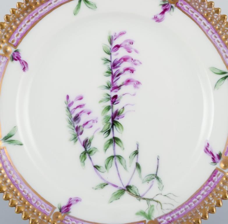 Royal Copenhagen Flora Danica. 
Side plate in hand-painted porcelain with flowers and gold decoration. 
Painted outside the factory.
Latin name.
In excellent condition.
Second factory quality.
Marked.
Diameter: 14.0 cm.