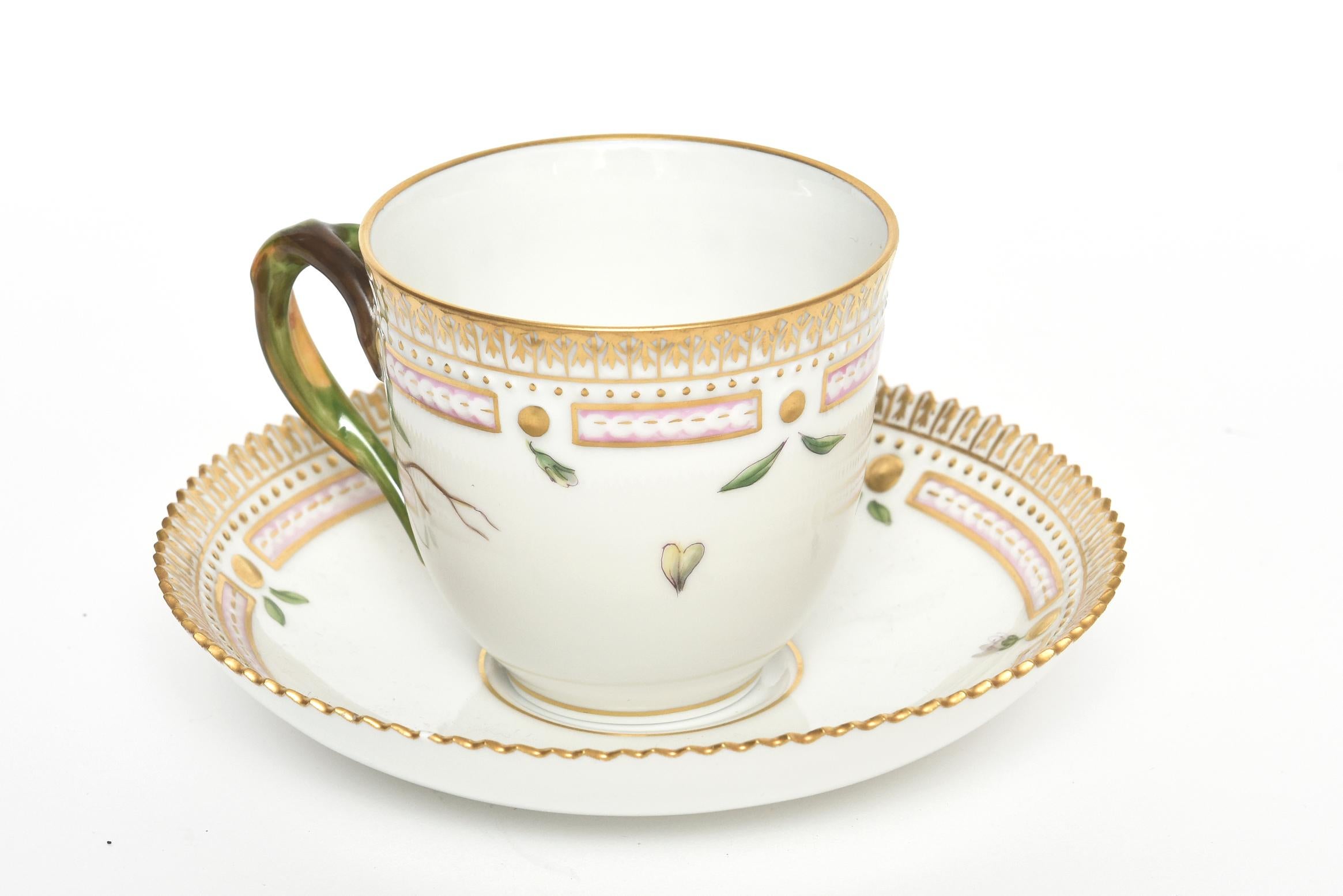 Beautiful hand painted Royal Copenhagen Flora Danica Stellaria sp coffee cup and Saucer features a white background, with a polychrome botanical specimen, crenellated gilt rim, factory marks to underside, and Latin inscription for specimen name.
