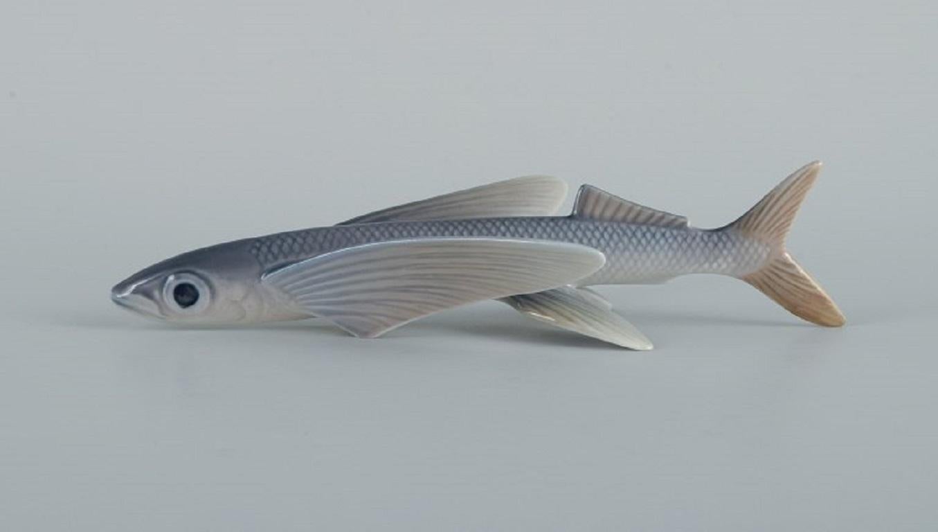 Royal Copenhagen flying fish figurine number 3050. 
Designed by Platen Hallermundt.
First factory quality.
Marked.
In perfect condition. 
Dimensions: L 16,0 x B 8,0 cm.

