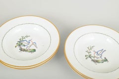 Royal Copenhagen. Four large deep porcelain plates with bird motif. Early 20th C