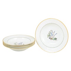 Royal Copenhagen. Four large deep porcelain plates with bird motif. Early 20th C