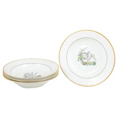 Royal Copenhagen. Four large deep porcelain plates with bird motif. Early 20th C