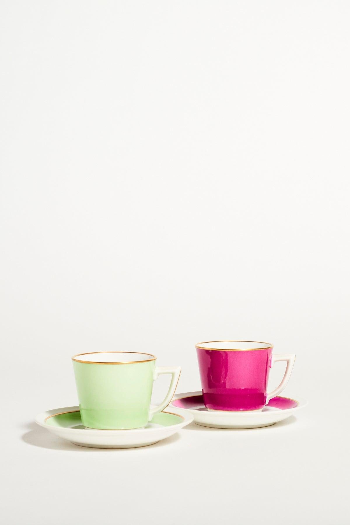 Royal Copenhagen quality porcelain demitasse set of two in fuchsia, mint green and crisp white accented with gold, elegant square handles, maker’s mark on base.

 