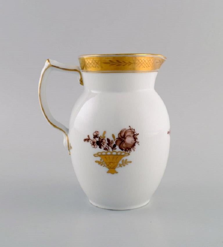 Royal Copenhagen Golden basket jug in porcelain with flowers and gold decoration. Model number 595/9235. Early 20th century.
Measures: 16 x 14 cm.
In excellent condition.
Stamped.
1st factory quality.