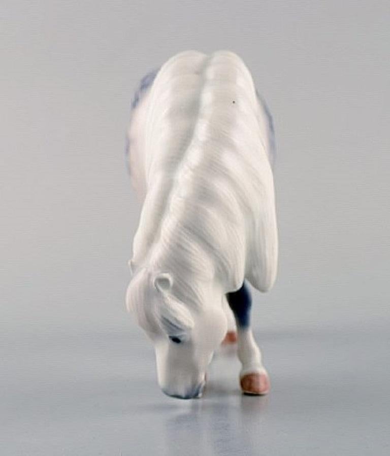 Royal Copenhagen horse figure, Shetland pony.
Decoration Number 4609.
Designed by Jeanne Grut.
Measures: 16 x 10.5 cm.
Perfect condition.
1st factory quality.