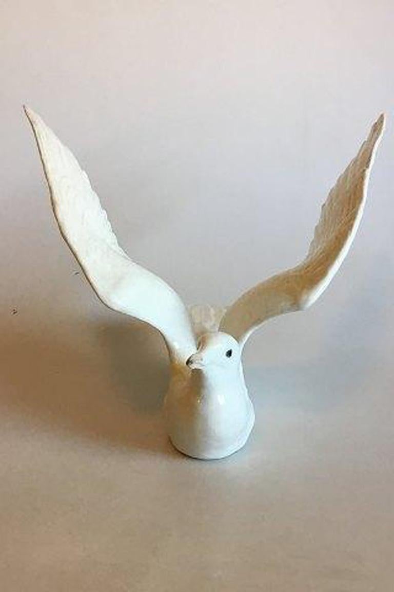 Royal Copenhagen ivory gull figurine made of porcelæn no 370.

Pictured in the Royal Copenhagen catalog 1910 on page 22. 

Measures: Beak to tale 32 cm / 12 19/32 in. 

Wing to wing 38 cm / 14 61/64 in. 

Height 28 cm / 11 1/32 in. 

Minor