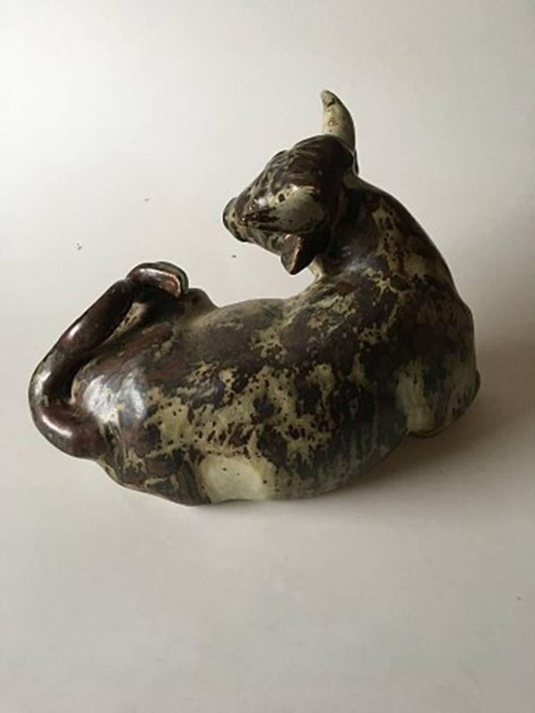 Royal Copenhagen Knud Kyhn stoneware figurine of a resting bull no. 2595. Measures 25 cm H, 37 cm L. In great condition.