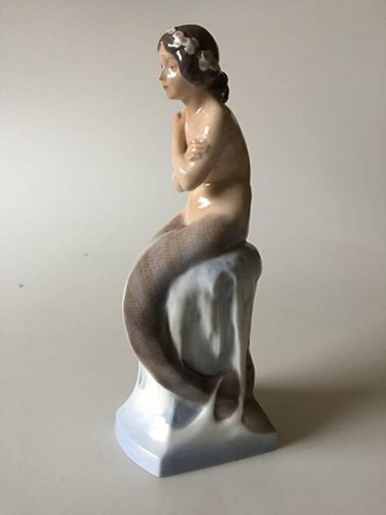 Royal Copenhagen mermaid on ice rock #1210. Measures: 26cm x 10cm, designed by Christian Thomsen. 4th quality. in perfect condition.