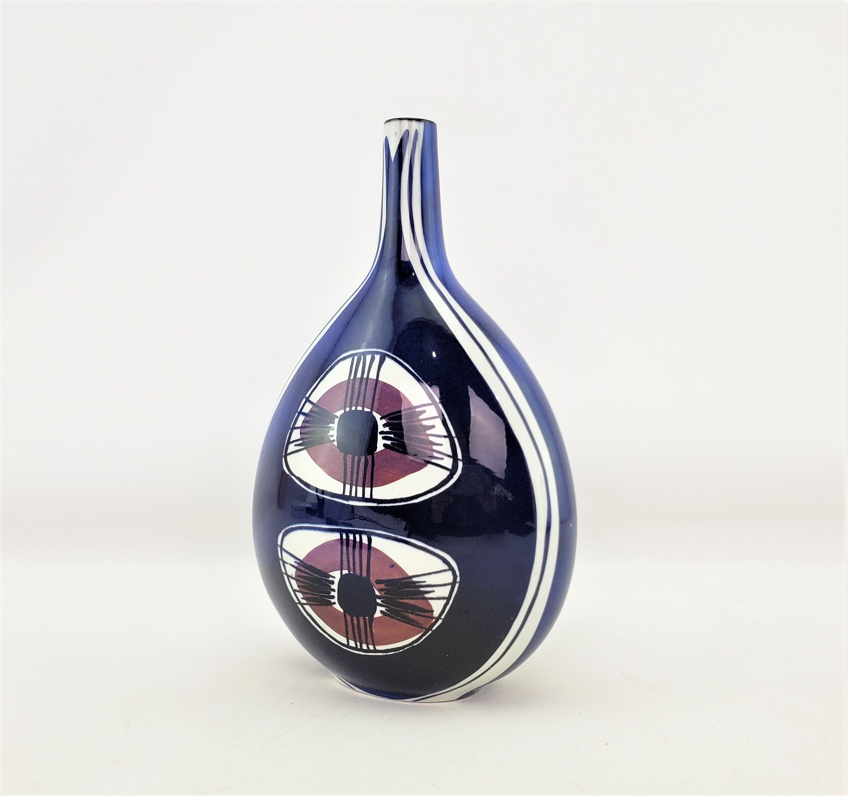 This vase was done by the well known Royal Copenhagen factory of Denmark in approximately 1965 in the period Mid-Century Modern style. This bottle shaped vase was designed by Inge-Lise Koefoed originally for Aluminia which later became Royal