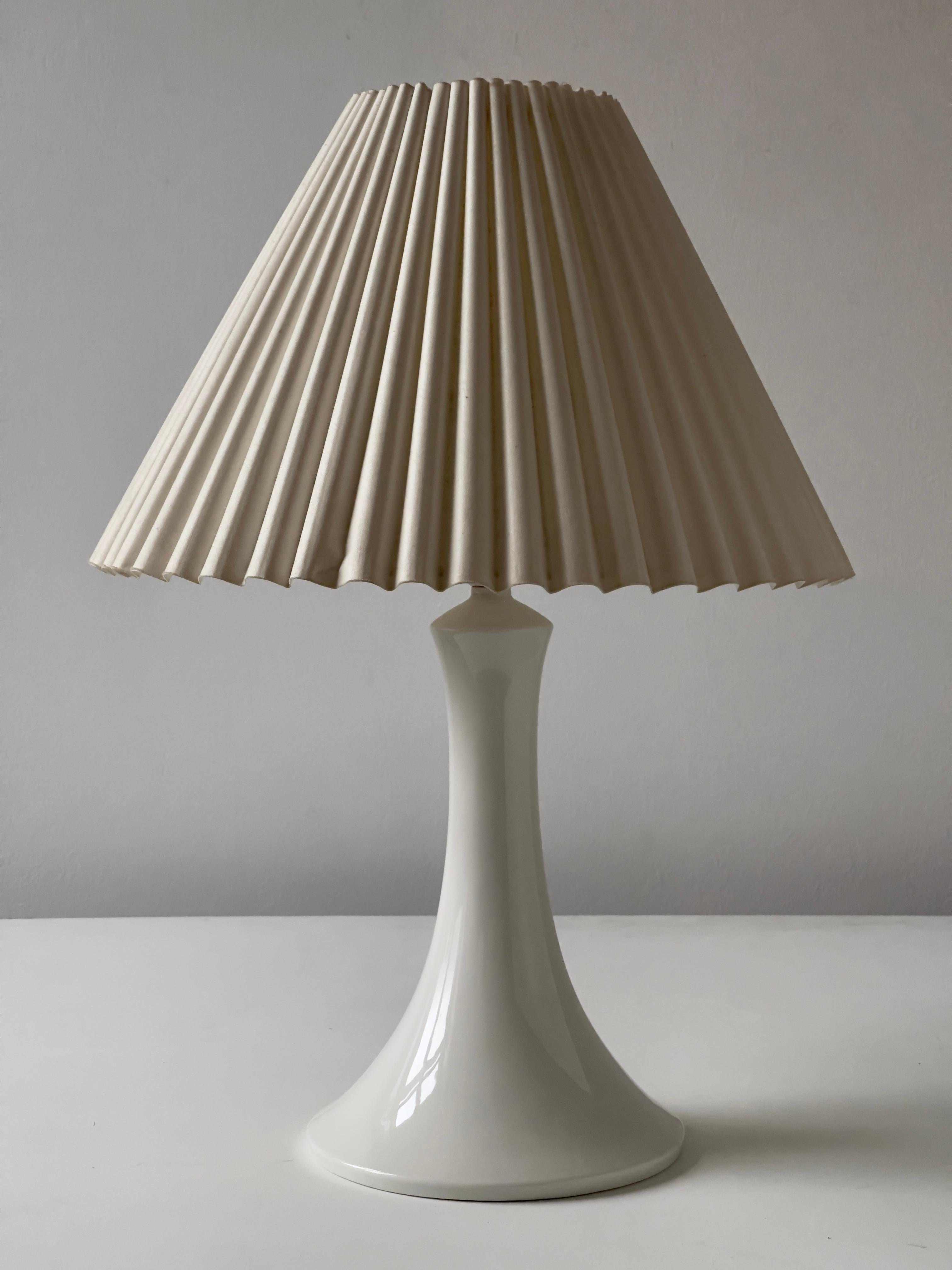 Produced by Royal Copenhagen 1960s. Beautiful condition and elegant white surface. Stamped. Height is from bottom to socket. Sold without lampshade.