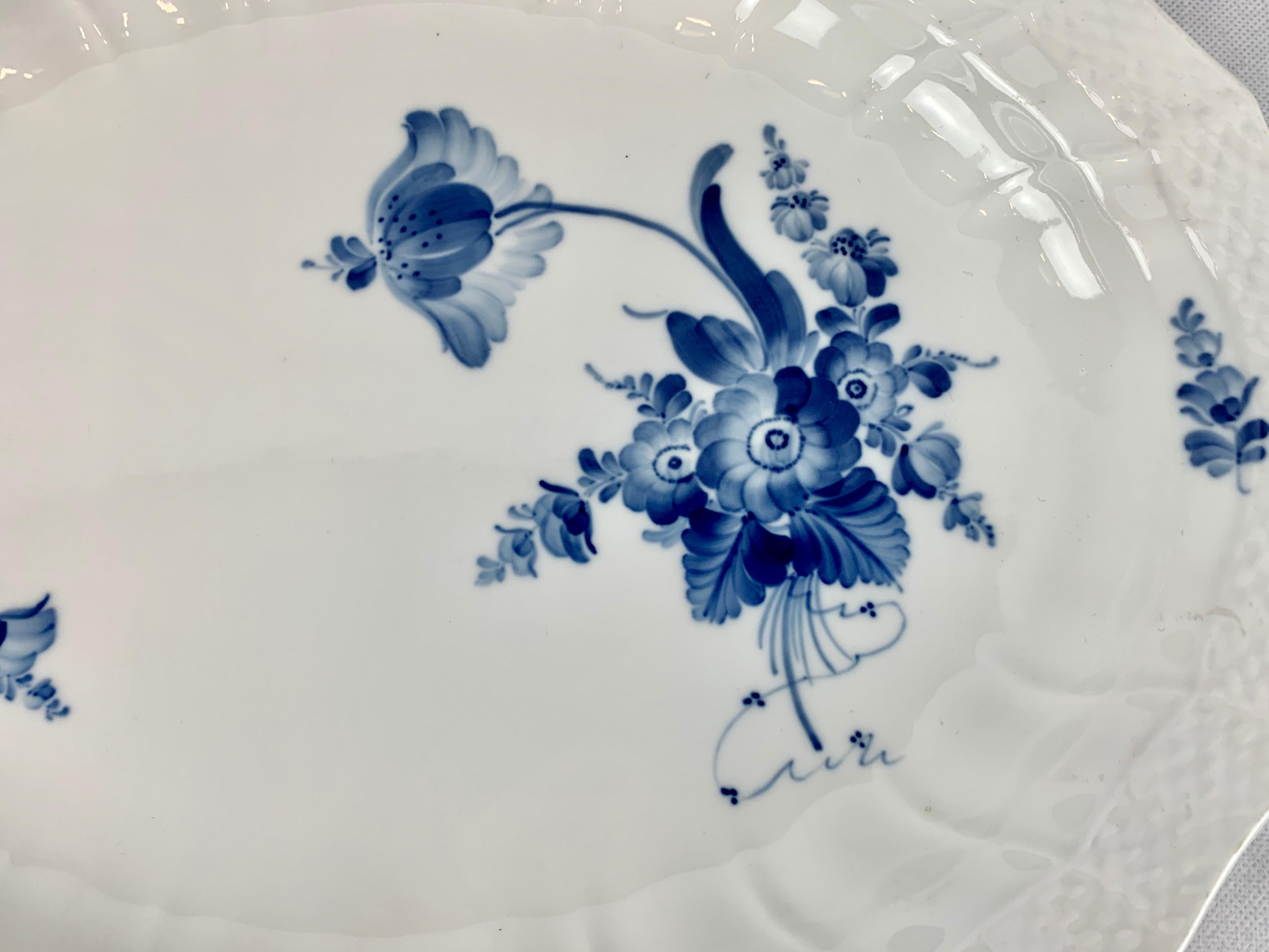 This large oval porcelain platter by Royal Copenhagen in the Rococo style is referred to as blue flower-curve. It was hand decorated in this dazzling cobalt blue. The 