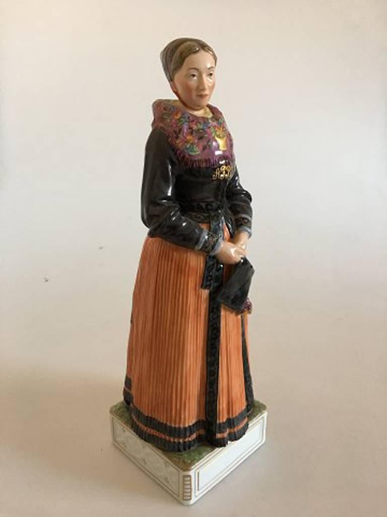 Royal Copenhagen over-glaze figurine #12101 Acht Pitter Bacher´s daugther Church-going costume; Amager. Measures 34 cm high and is in perfect condition.
