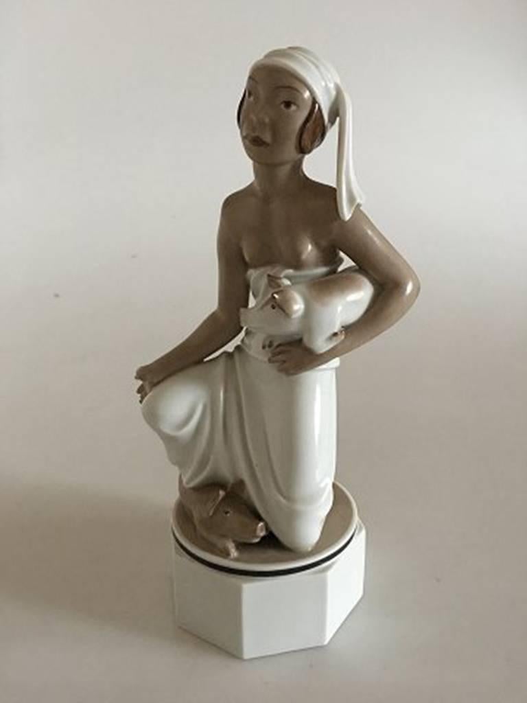 Royal Copenhagen over-glazed figurine of oriental woman with pigs #12456. Measures: 20 cm tall. First quality. In perfect condition.