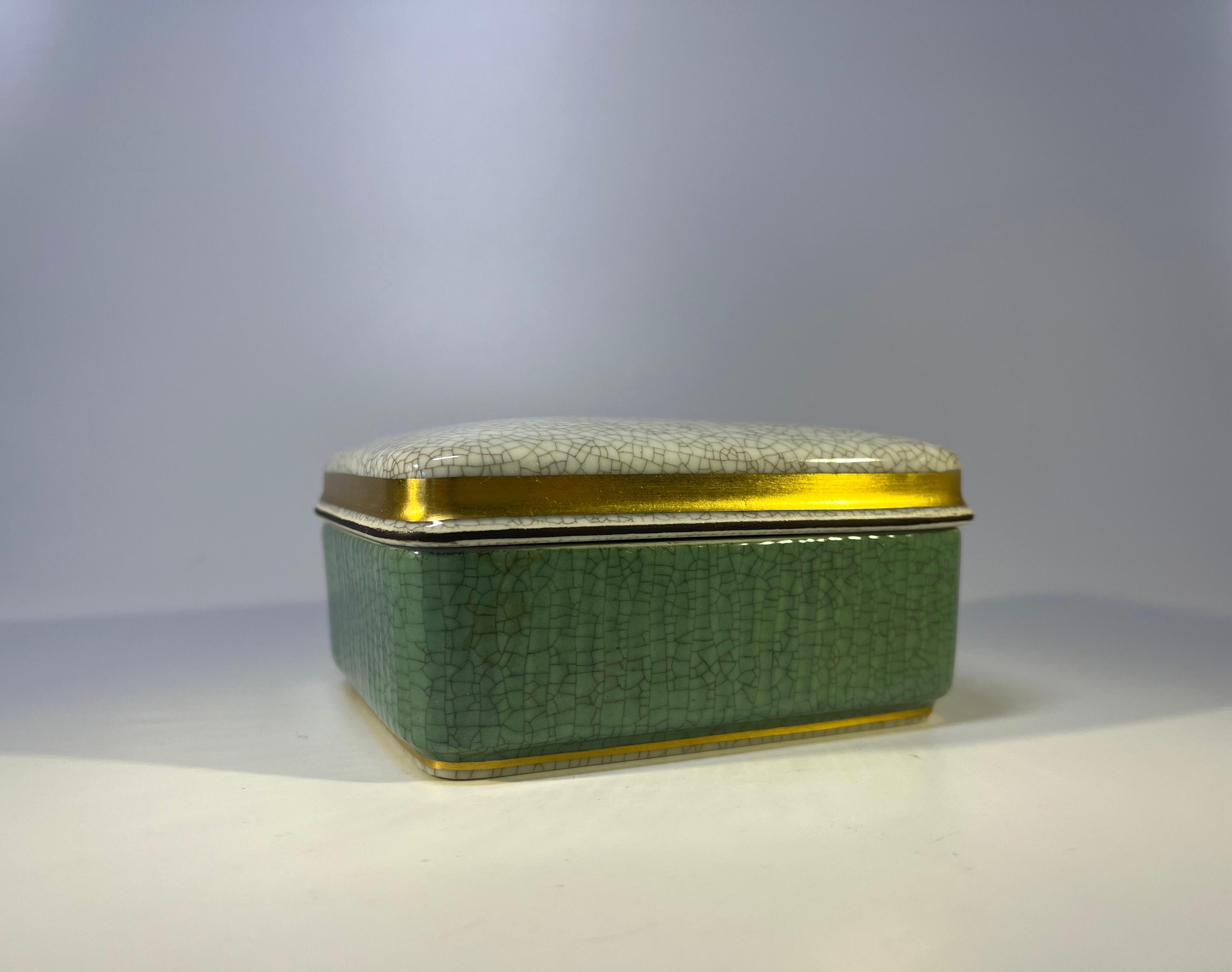Royal Copenhagen pale green crackle glaze box with grey crackle glaze lid. Trimmed with gilt banding
Circa 1969-1973
Signed and numbered 4441
Height 2 inch, Width 4.25 inch, Depth 3.60 inch
In very good condition. Underglaze dimple on base.