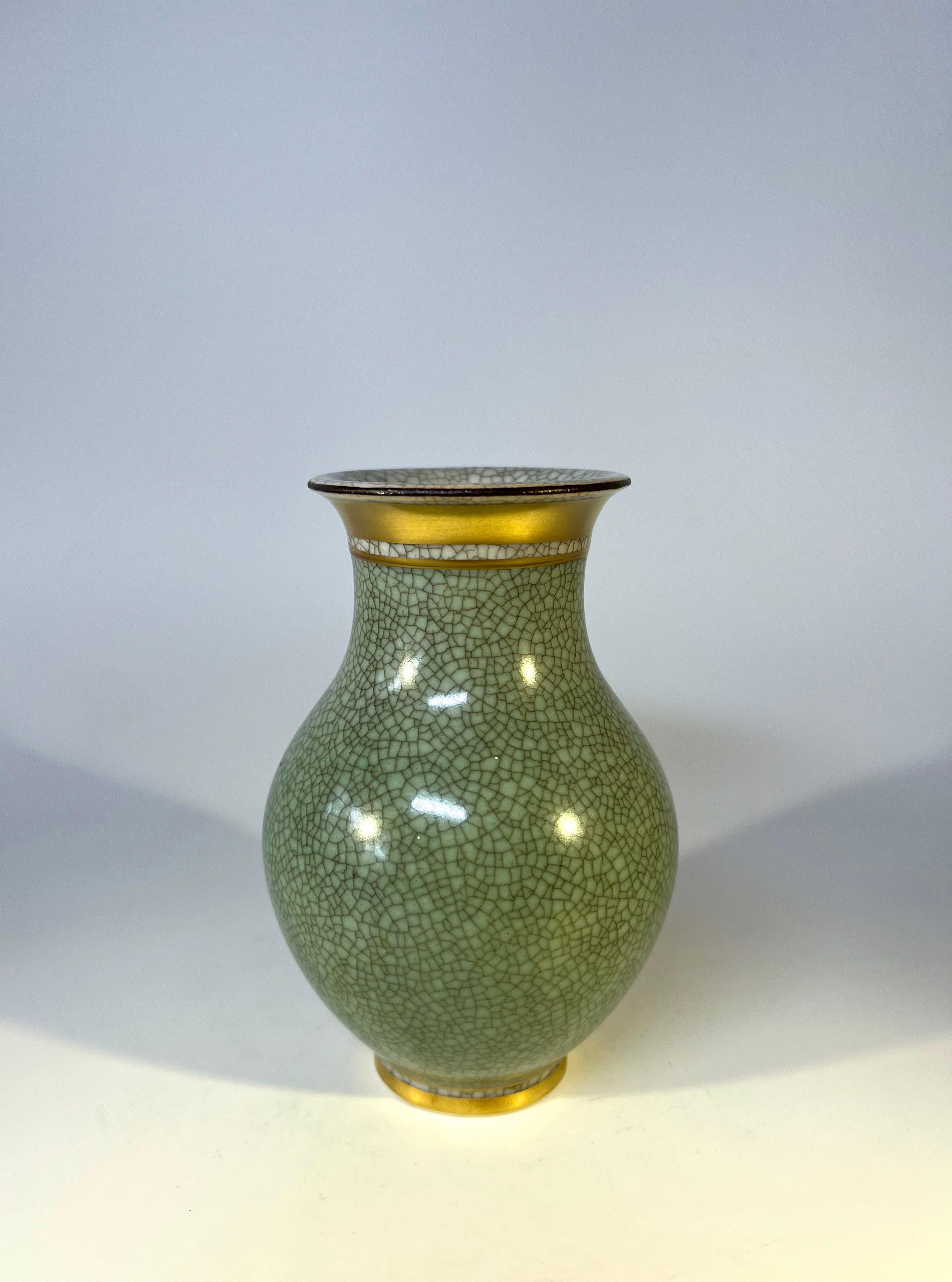 Royal Copenhagen porcelain gilded pale green and grey crackle glazed petit baluster vase 
A diminutive, quality vase from Royal Copenhagen
Circa 1960's
Stamped and numbered 2736
Height 4.5 inch, Diameter 3 inch
Very good condition. 
Wear consistent