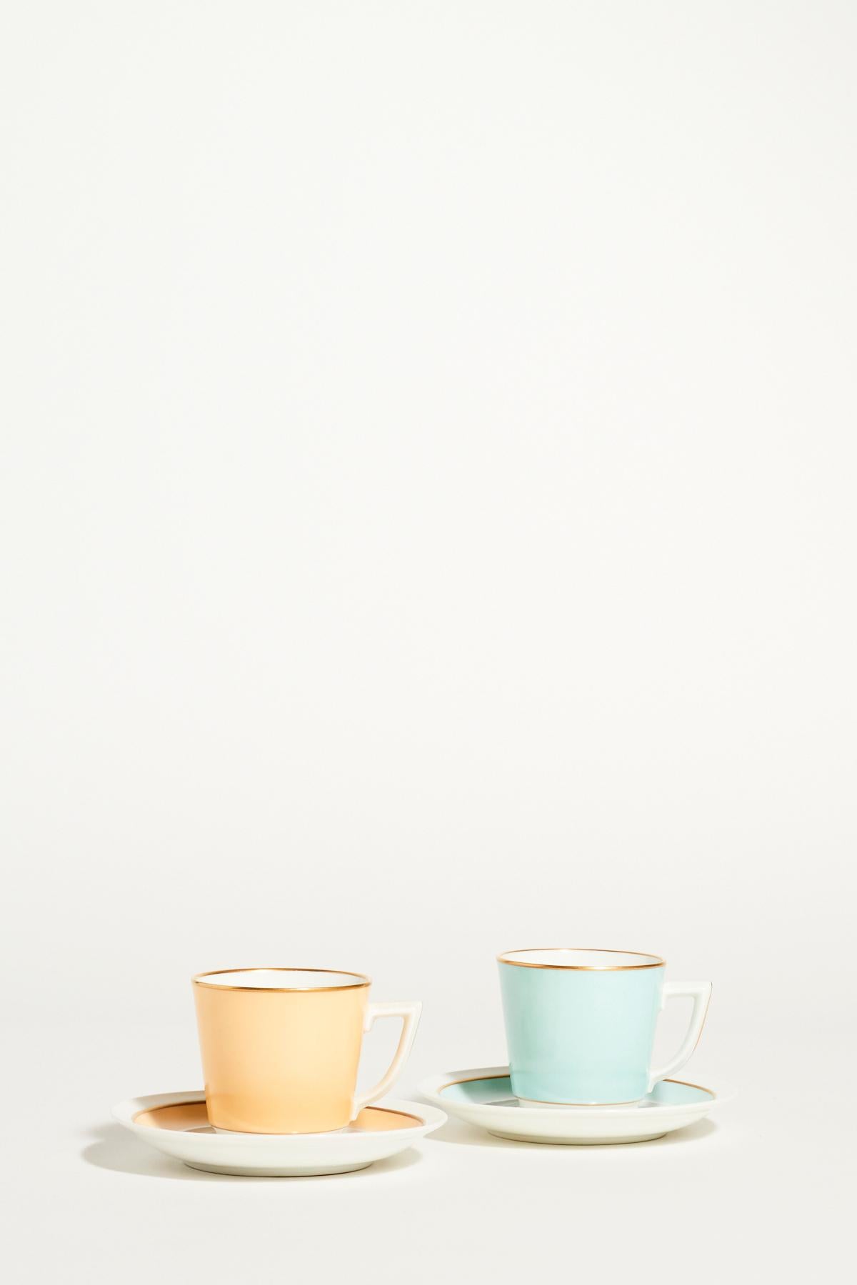 Royal Copenhagen quality porcelain demitasse set of two in pale yellow, mint and crisp white accented with gold, elegant square handles, maker’s mark on base.

 