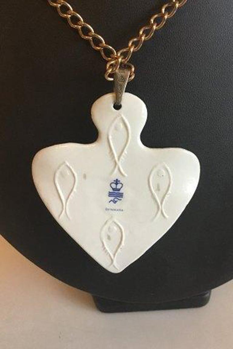 Royal Copenhagen Pendant of porcelain shaped and decorated as a Flounder. Designed by Nils Thorson. Sterling Silver by Anton Michelsen.

Measures Pendant: 7 cm / 2 3/4 in. Chain: 60 cm / 23 5/8 in.
