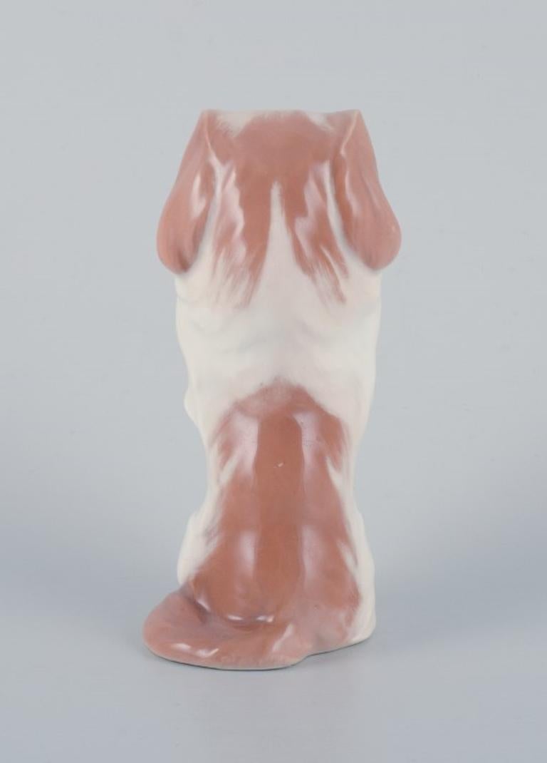 Glazed Royal Copenhagen, porcelain figure of a standing Pekingese dog. 
