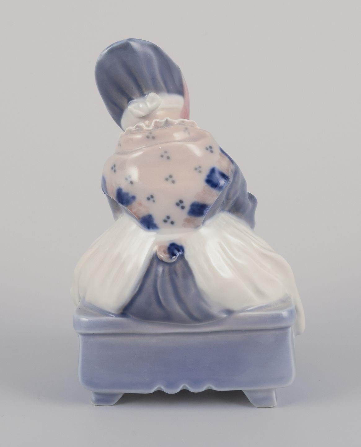 Royal Copenhagen porcelain figurine. Amager girl in traditional dress knitting. mediados del siglo XX en venta