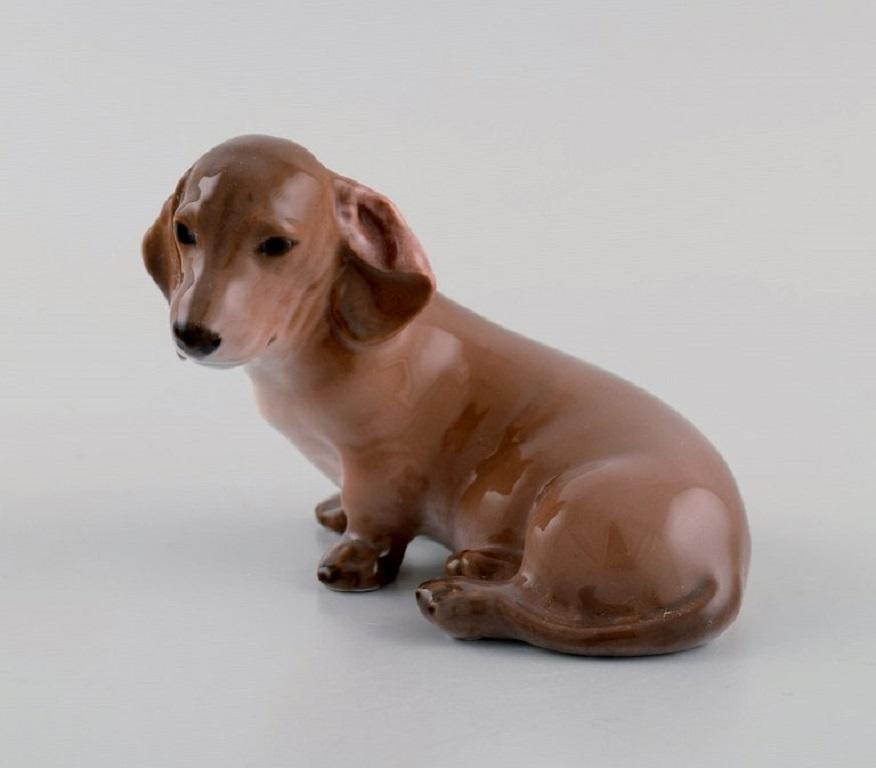 Royal Copenhagen porcelain figurine. 
Dachshund. Early 20th century. Model number 3140.
Measures: 11 x 7.5 cm.
In excellent condition.
Stamped.
1st factory quality.