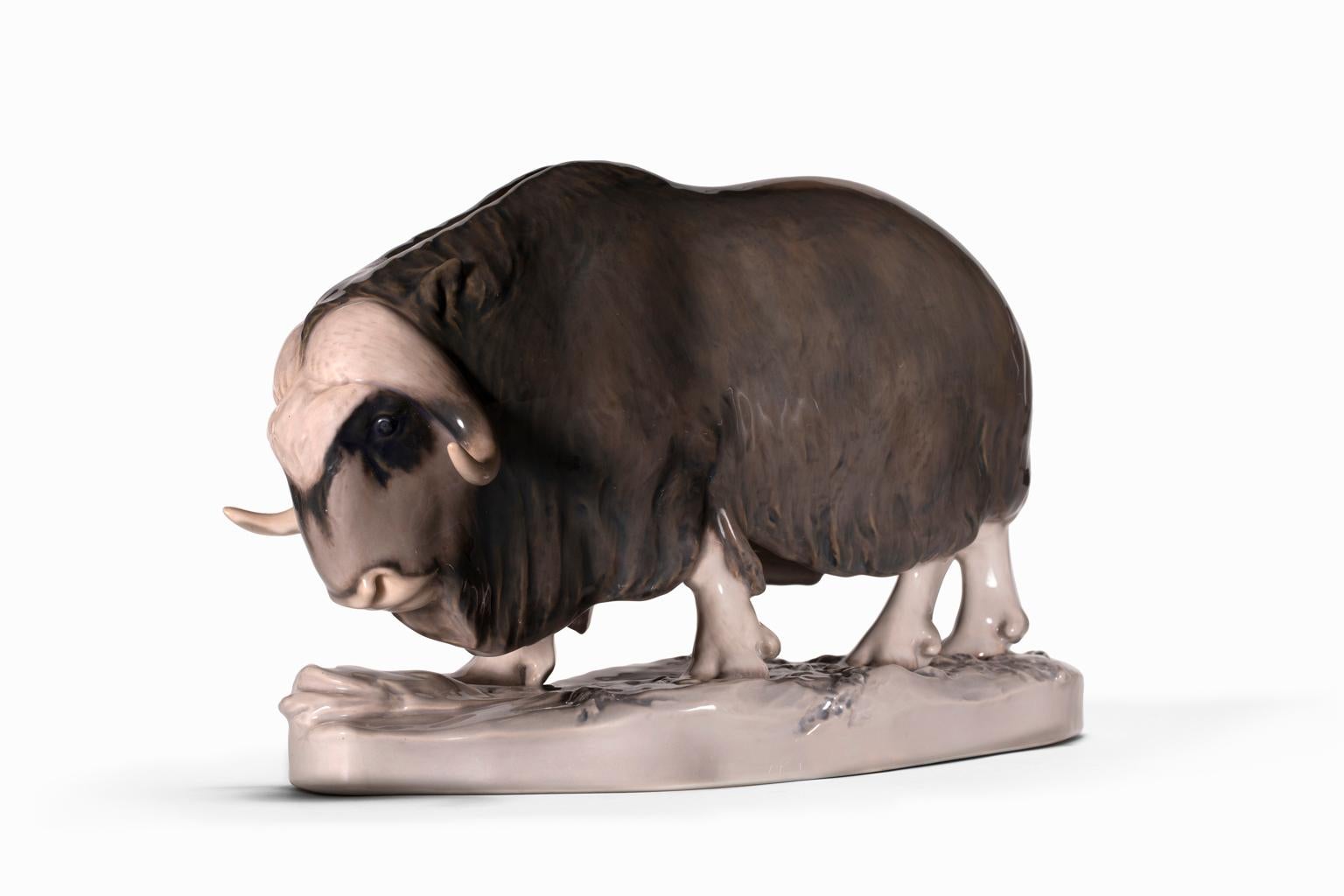 The beautiful and majestic Musk Ox is captured in all its strength and quiet beauty in #530 by Erik Nielsen in 1903 for Royal Copenhagen. The markings on verso indicated the piece was created prior to 1922. It is glazed in soft browns and mauve with