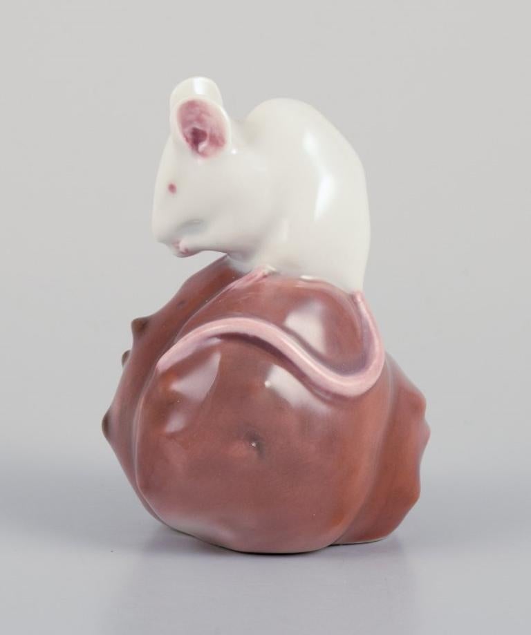 Royal Copenhagen. Figurine de souris sur un châtaignier
 Modèle 571. 
Datant approximativement des années 1920. 
Marqué. 
Première qualité d'usine. En parfait état. 
Dimensions : L 5,0 cm x H 6,0 cm : L 5,0 cm x H 6,0 cm.