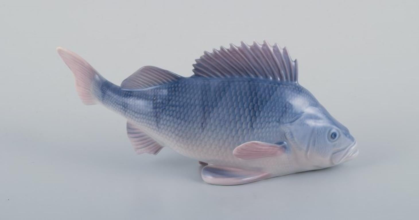 Royal Copenhagen, porcelain figurine of a perch.
Model: 1138.
Early 20th century.
Marked.
First factory quality.
Perfect condition.
Dimensions: Length 19.5 cm, Height 8.5 cm.