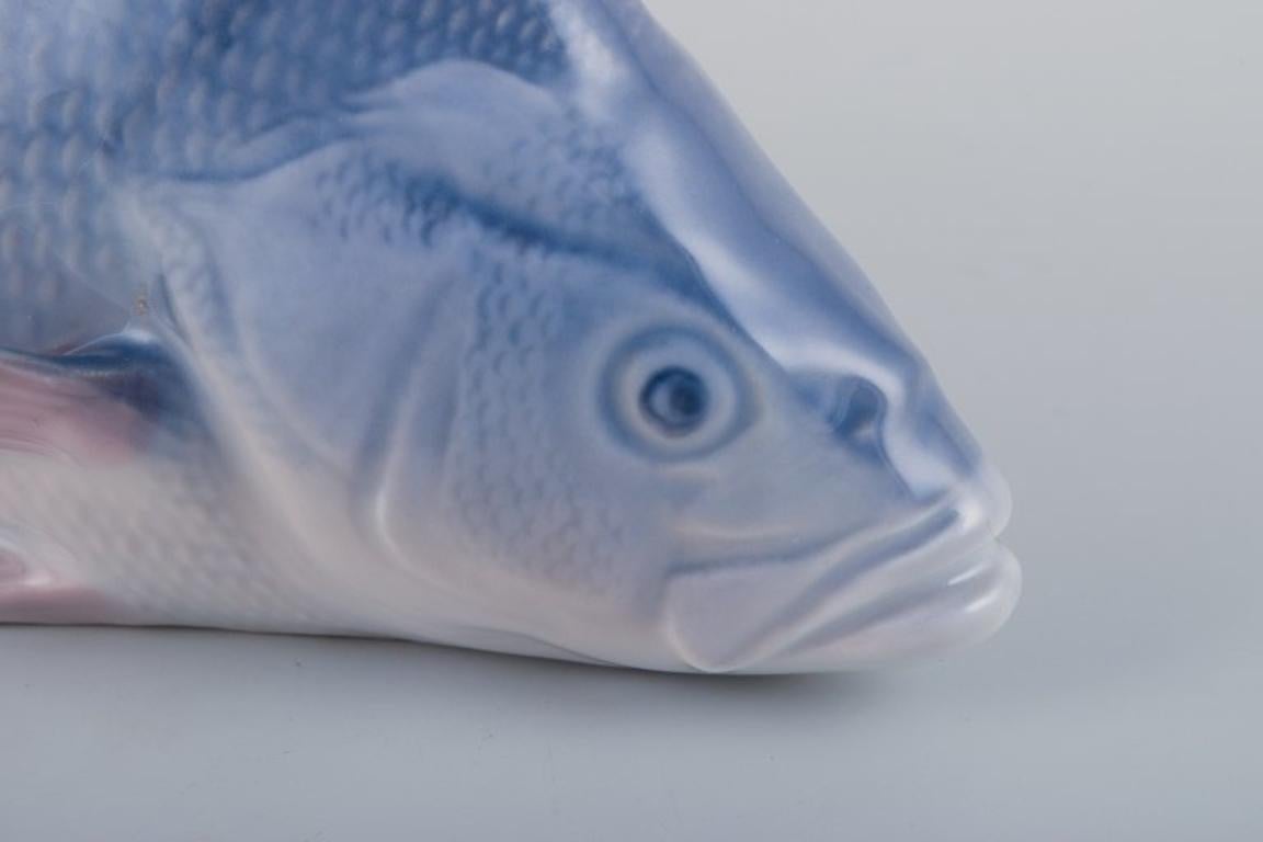 Glazed Royal Copenhagen, porcelain figurine of a perch. Early 20th C. For Sale