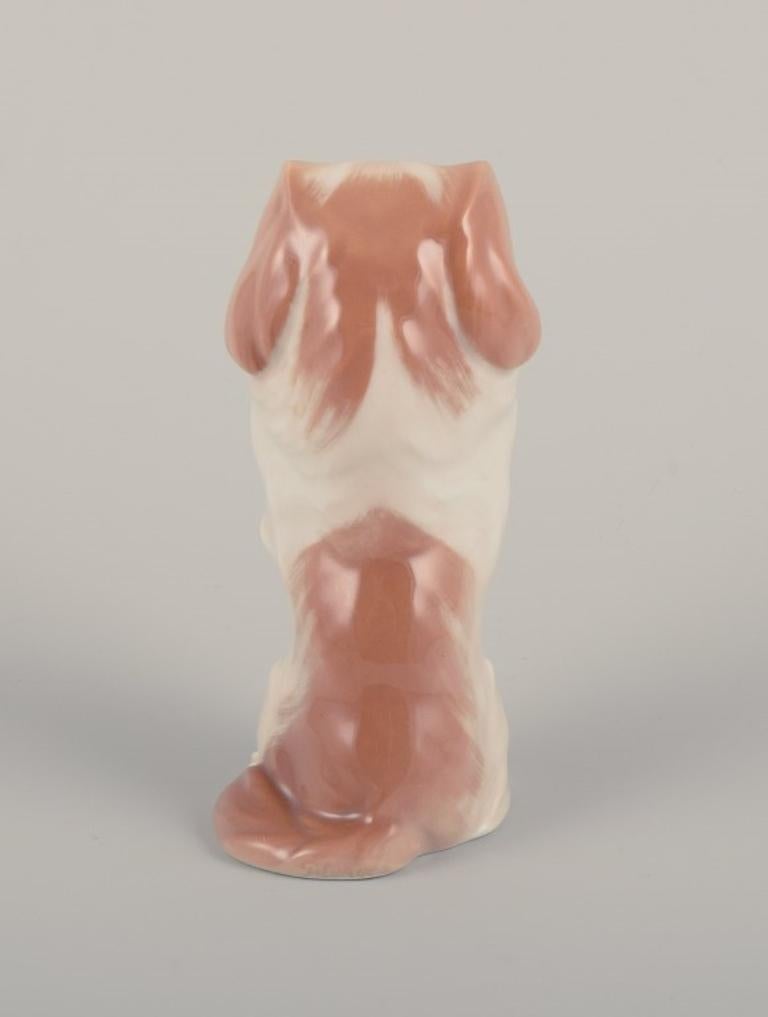 Mid-20th Century Royal Copenhagen, porcelain figurine of a standing Pekingese.
