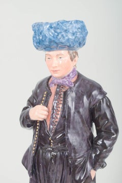 Royal Copenhagen. Porcelain figurine of man in traditional regional costume.