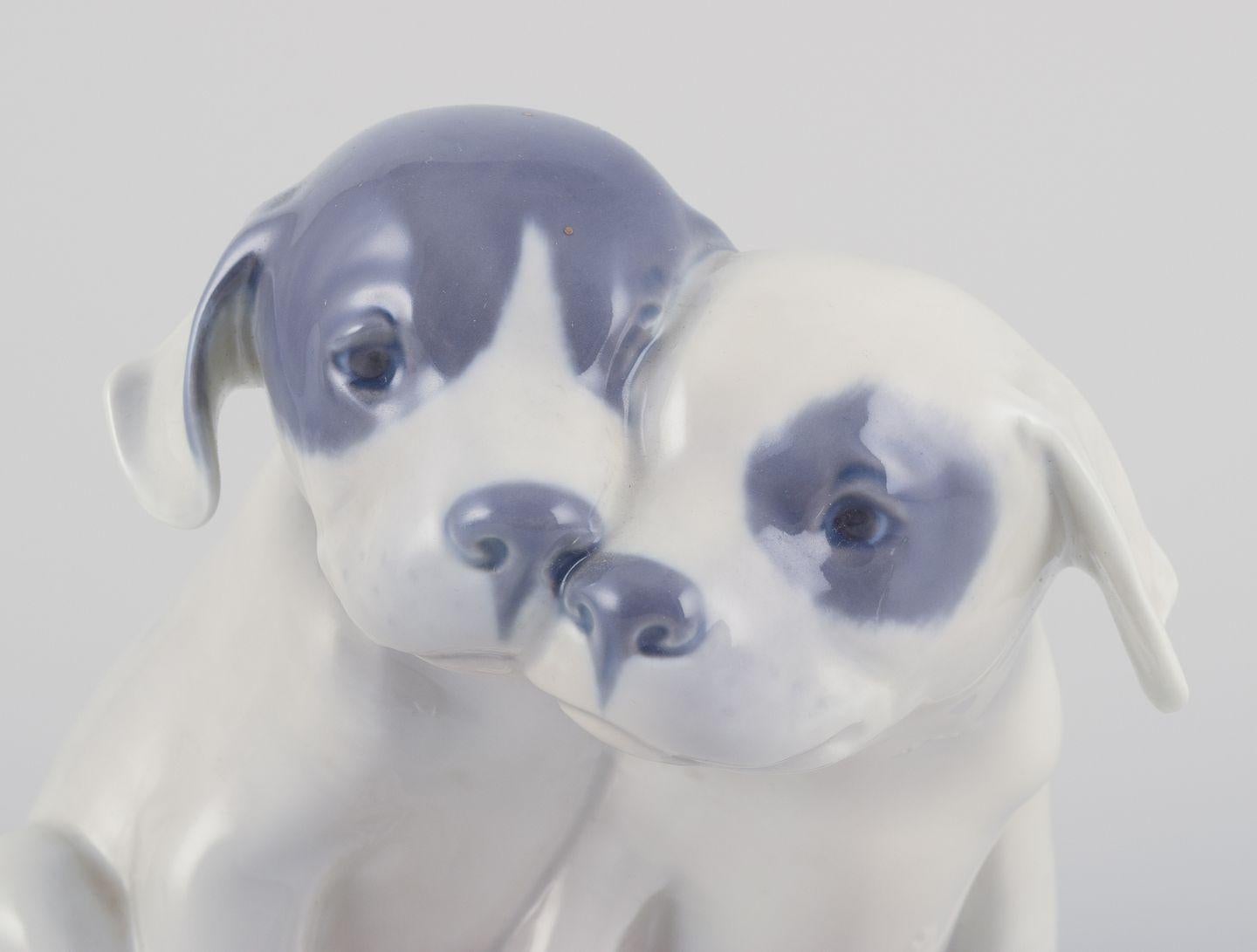 Pre-owned goods are exempt from import duties for U.S. customers. 
Therefore, no import tariffs will be applicable to your purchase.

Royal Copenhagen, porcelain figurine of two Pointer puppies.
Underglaze.
Model number: 260.
Circa 1930.
Perfect