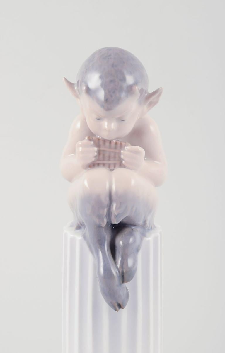 PRE-OWNED GOODS ARE EXEMPT FROM IMPORT TARIFFS FOR U.S., UK, AUSTRALIAN & CANADIAN CUSTOMERS.   
THEREFORE, NO IMPORT TARIFFS WILL BE APPLICABLE TO YOUR PURCHASE. 

Royal Copenhagen, porcelain figurine.
Whistling Pan sitting on a pedestal with a