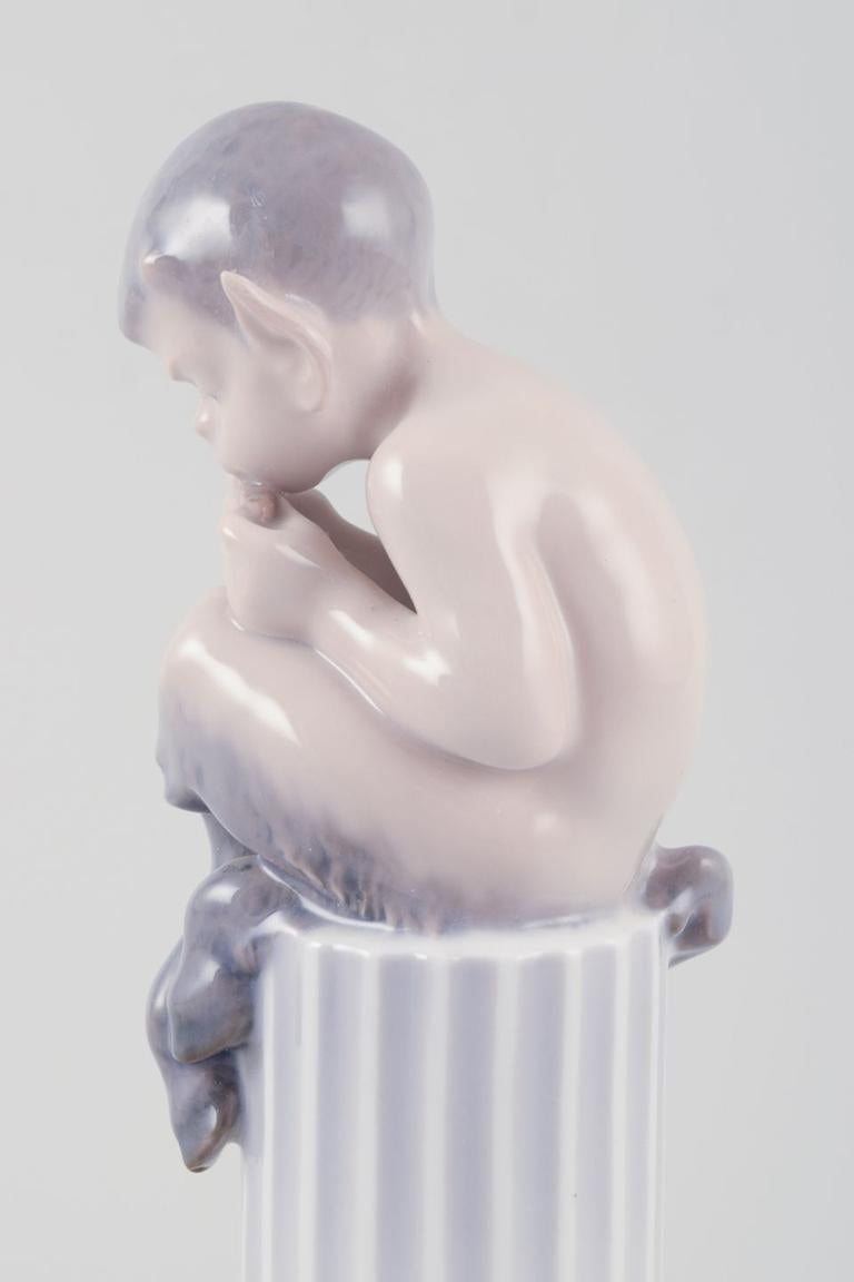 Mid-20th Century Royal Copenhagen, porcelain figurine. Whistling Pan sitting on a pedestal. For Sale