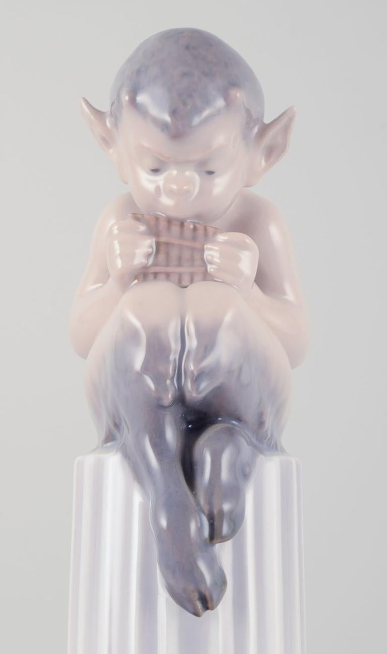 Royal Copenhagen, porcelain figurine. Whistling Pan sitting on a pedestal. For Sale 1