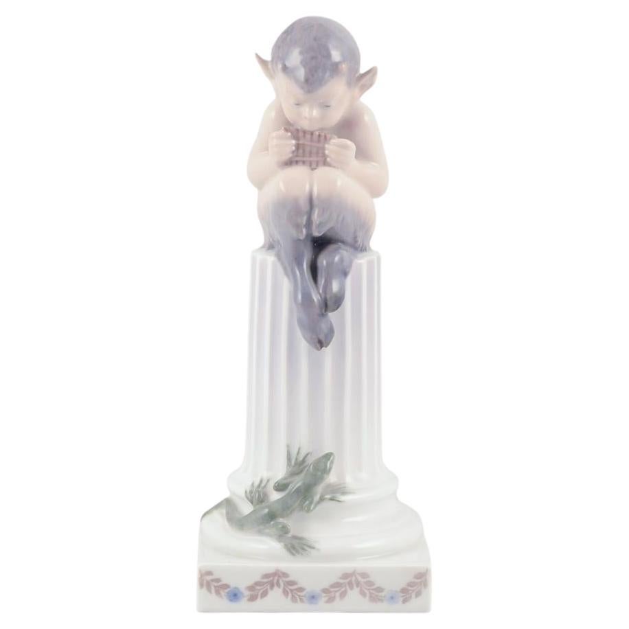 Royal Copenhagen, porcelain figurine. Whistling Pan sitting on a pedestal. For Sale