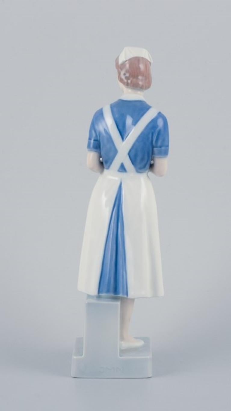 Glazed Royal Copenhagen, rare porcelain figurine of a nurse. Model: 4507/156.  For Sale