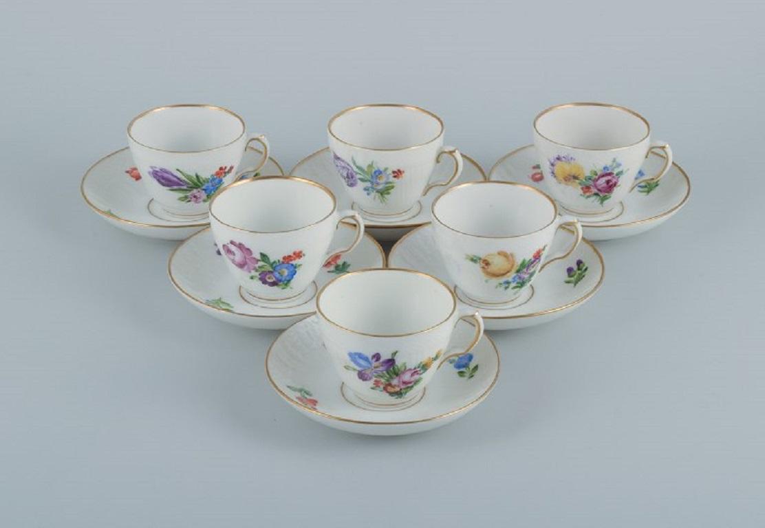 Royal Copenhagen, Saxon flower. Five coffee cups with saucers. 
Model number 493/1549.
Early 20th century.
Second factory quality.
In excellent condition.
Marked.
Cup dimensions: D 7.5 (without handle) x H 6.0 cm
Saucer dimensions: D 13.0 cm.