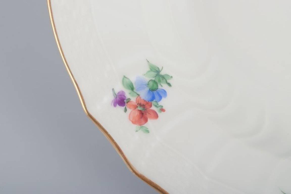 Hand-Painted Royal Copenhagen Saxon Flower. Four deep plates in porcelain. Early 20th C. For Sale