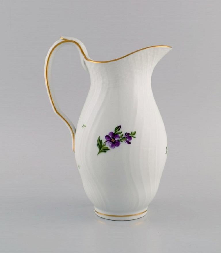 Royal Copenhagen Saxon Flower jug in hand-painted porcelain with flowers and gold decoration. 
Model number 493/1609. Early 20th century.
Measures: 20.5 x 15 cm.
In excellent condition.
Stamped.
2nd Factory quality.