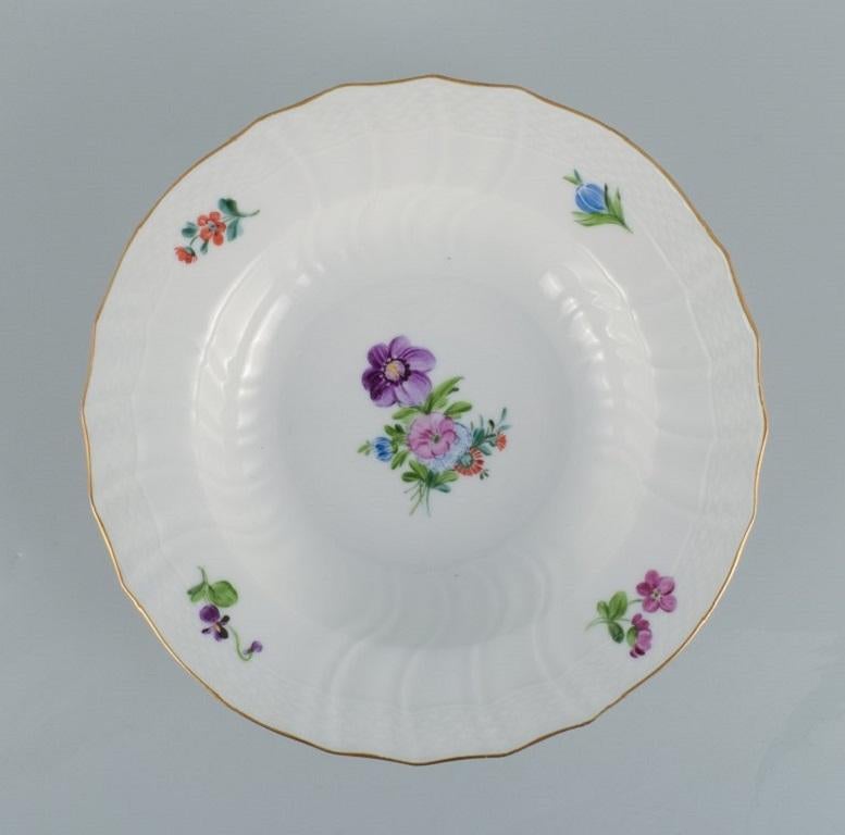 Royal Copenhagen Saxon Flower. 
Six deep plates in hand-painted porcelain with flowers and gold decoration.
Model number 493/xxxx.
In excellent condition.
Marked.
Second factory quality.
Dimensions: D 24,5 x H 6,0 cm.