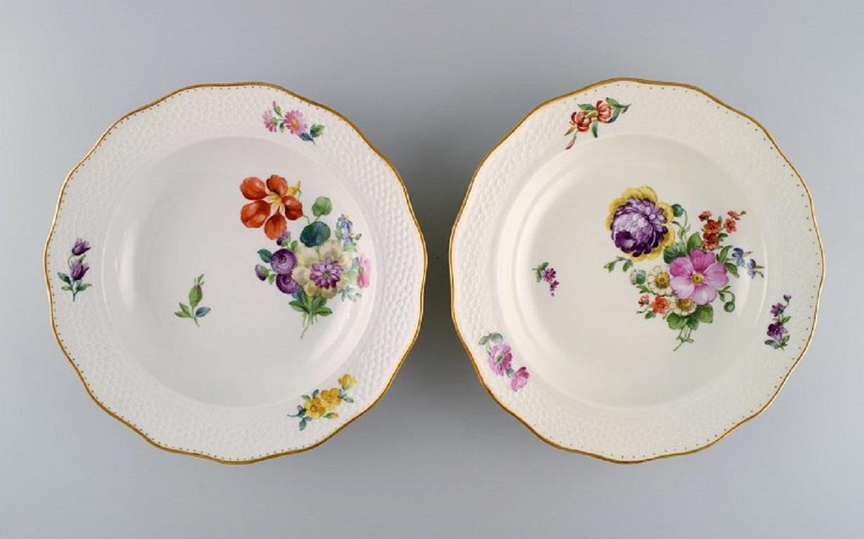 Royal Copenhagen Saxon flower special version. 
Eight rare deep plates with hand-painted flowers and gold decoration. Approx. 1900.
Measures: 25 x 4.5 cm.
In excellent condition.
Signed.
1st Factory quality.