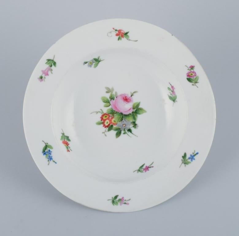 Royal Copenhagen, set of four rare and antique Saxon Flower porcelain plates. 
Hand-painted with polychrome floral motifs. 
Three deep plates and one dinner plate.
1810-1850.
Marked.
First factory quality.
In excellent condition.
Dinner plate with a