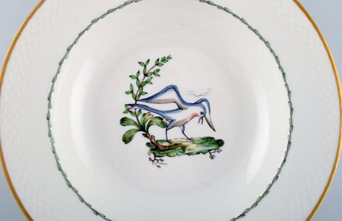 Royal Copenhagen soup plate in hand painted porcelain with bird motifs and gold decoration. Early 20th century. 17 pcs in stock.
Measures: 25.5 x 5 cm.
In very good condition.
Stamped.
2nd factory quality.