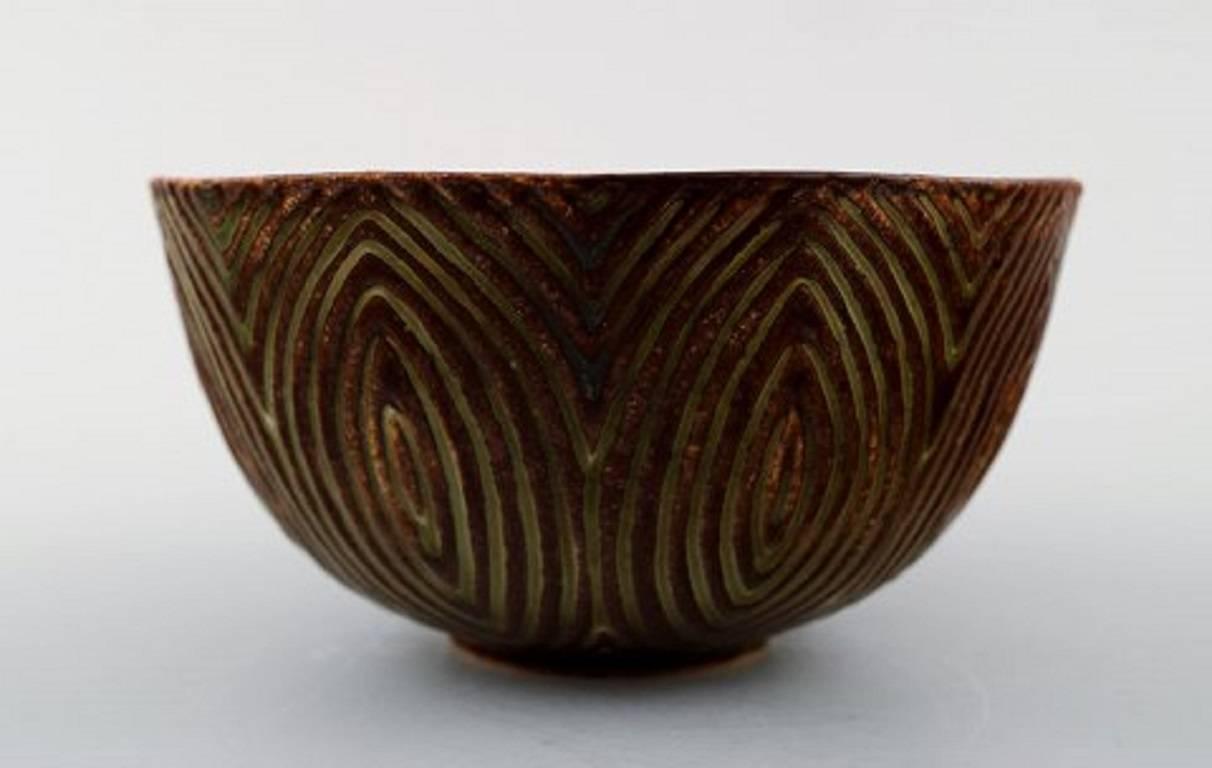 Royal Copenhagen stoneware bowl by Axel Salto in fluted style.
Model no. 20720.
Beautiful sung glaze. 
Marked.
1. Quality, in very good condition.
Measures 11.5 x 6.5 cm.